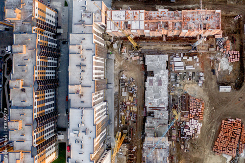 Construction and construction of high-rise buildings, the construction industry with working equipment and workers. View from above, from above. Background and texture