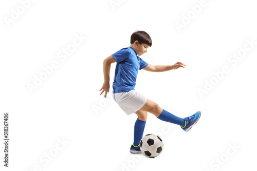 Fototapeta Naklejka Na Ścianę i Meble -  Boy dribbling a soccer ball