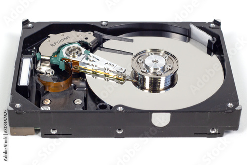 Disassemble a hard drive from a computer, a hard drive with a mirror effect a hard drive from a computer, a hard drive with a mirror effect Part of a computer, close-up HDD