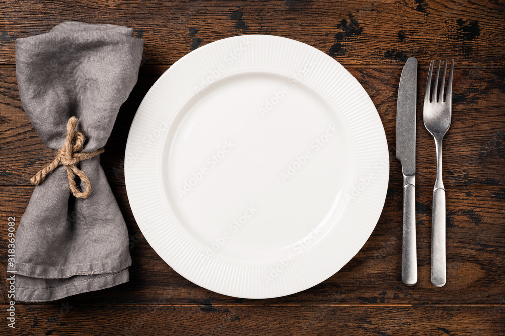 Table setting with empty white plate, cutlery and table napkin. Top view,  copy space for text. Dinner table Stock Photo | Adobe Stock
