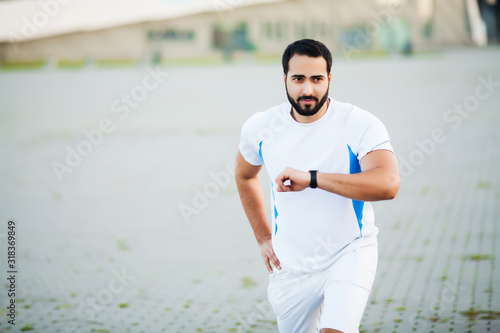 Fitness. Young man running in urban environment