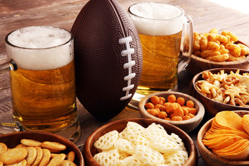 Chips, salty snacks, football and Beer on a table. Great for Bowl Game snack projects.