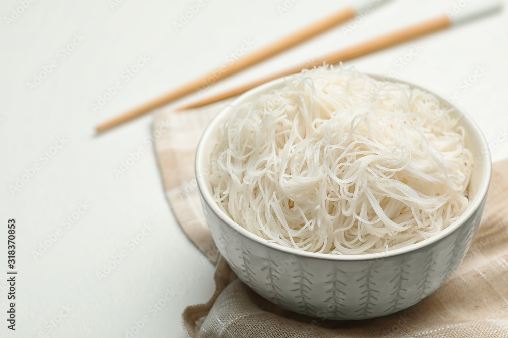 Tasty cooked rice noodles on white table