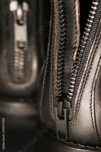 Leather black boots with a zipper on the back, closeup