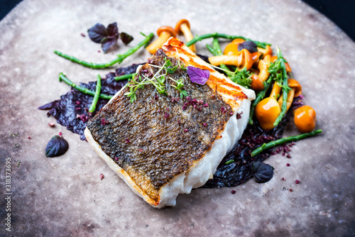 Photography Gourmet fried European skrei cod fish filet with glasswort, fungi and algae as c