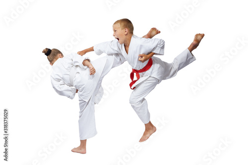 On a white background sportsmens are beating blows karate