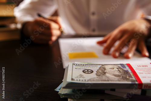Closeup view of money and laywer concept on the desk. Male attorney behind