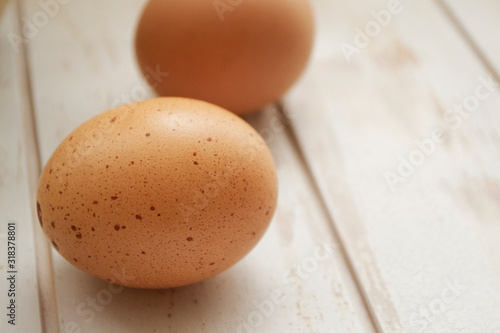 chicken eggs on white wooden shabby background close up photo