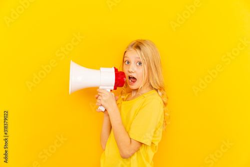 Kid shouting through vintage megaphone. Communication concept. Blue sky background as copy space for your text.