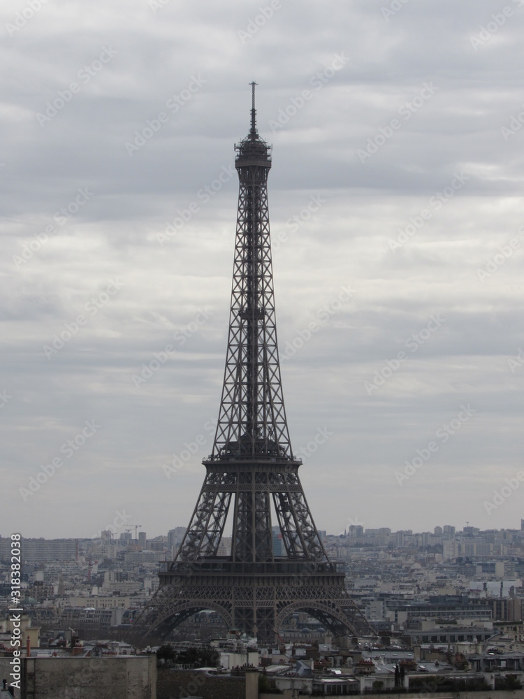 View of the Eiffel Tower as seen from the Arc de Triomphe in Paris, France on a cloudy day