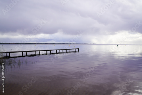 wood access empty pontoon sunrise blue water winter on Lake Hourtin in Gironde france
