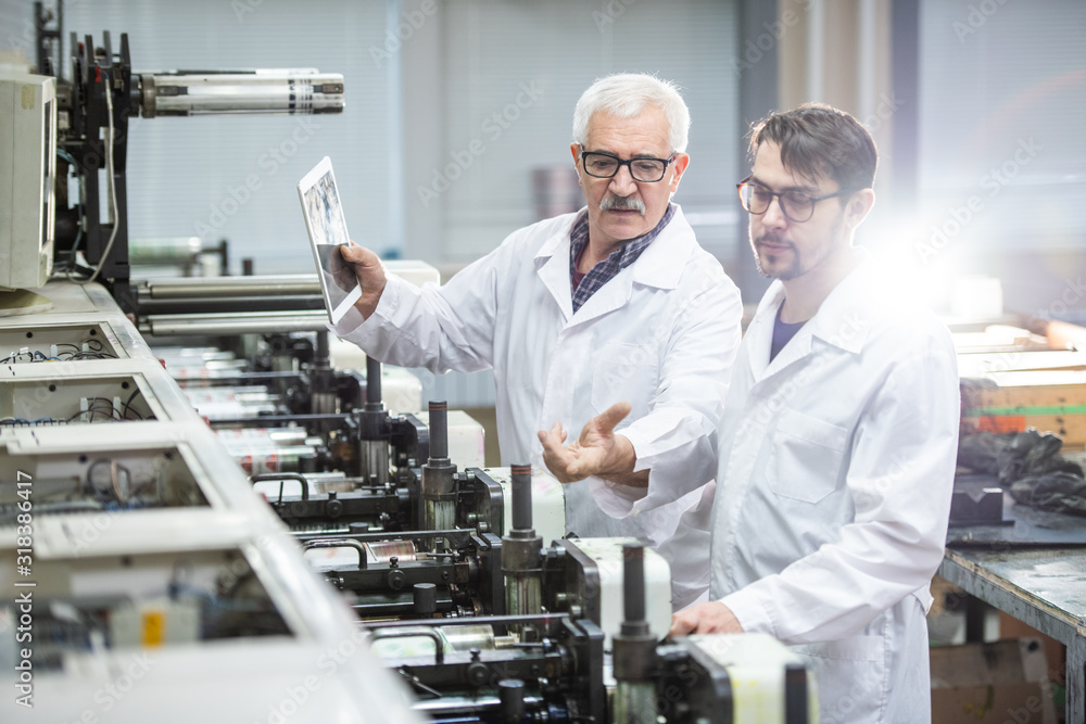 Explaining printing process to colleague Explaining printing process to colleague