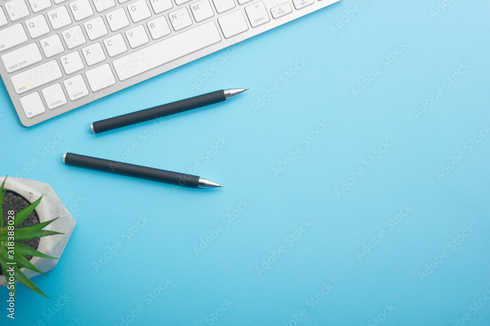 Blue desk office with laptop, smartphone and other work supplies with cup of coffee. Top view with copy space for input the text. Designer workspace on desk table essential elements on flat lay Blue desk office with laptop, smartphone and other work supplies with cup of coffee. Top view with copy space for input the text. Designer workspace on desk table essential elements on flat lay