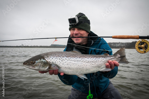 Flyfishing angler with sea trout trophy