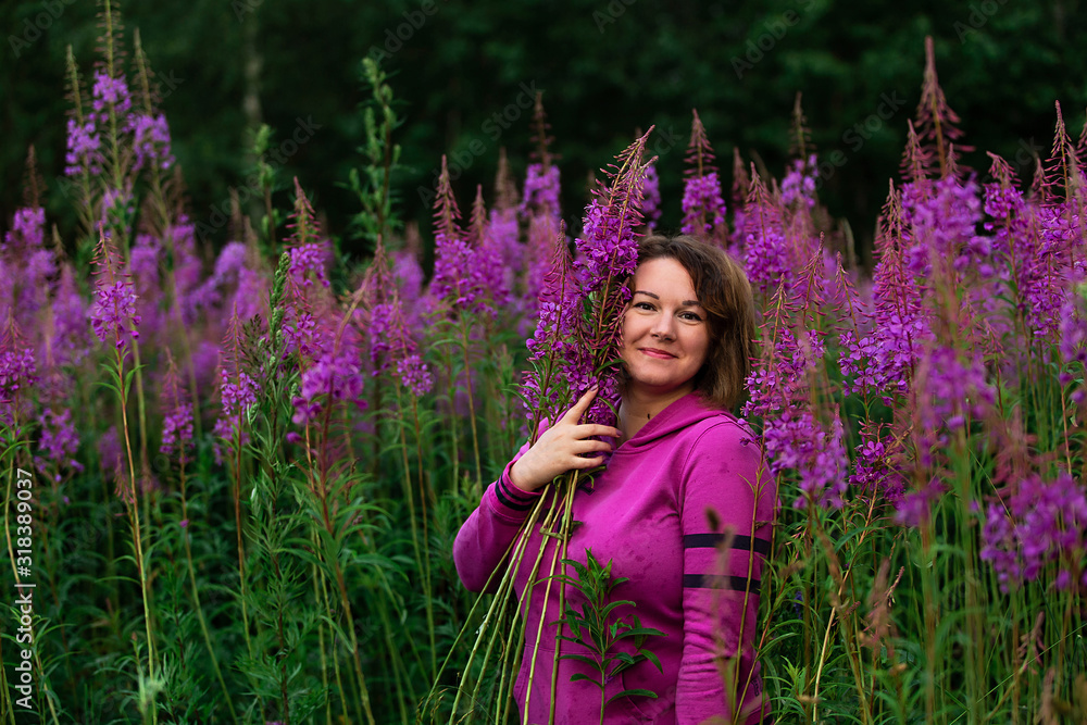 Smiling woman amidst bright flowers in a meadow Smiling woman amidst bright flowers in a meadow