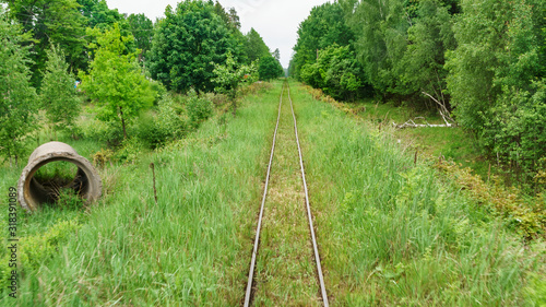 Railway top view. Railroad and green grass on the sides. The part of narrow gauge rail track for train
