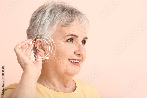 Senior woman with hearing a...
