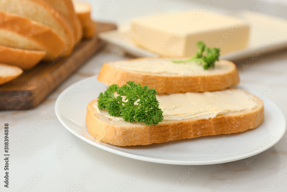 Plate with slices of bread and fresh butter on white background Plate with slices of bread and fresh butter on white background