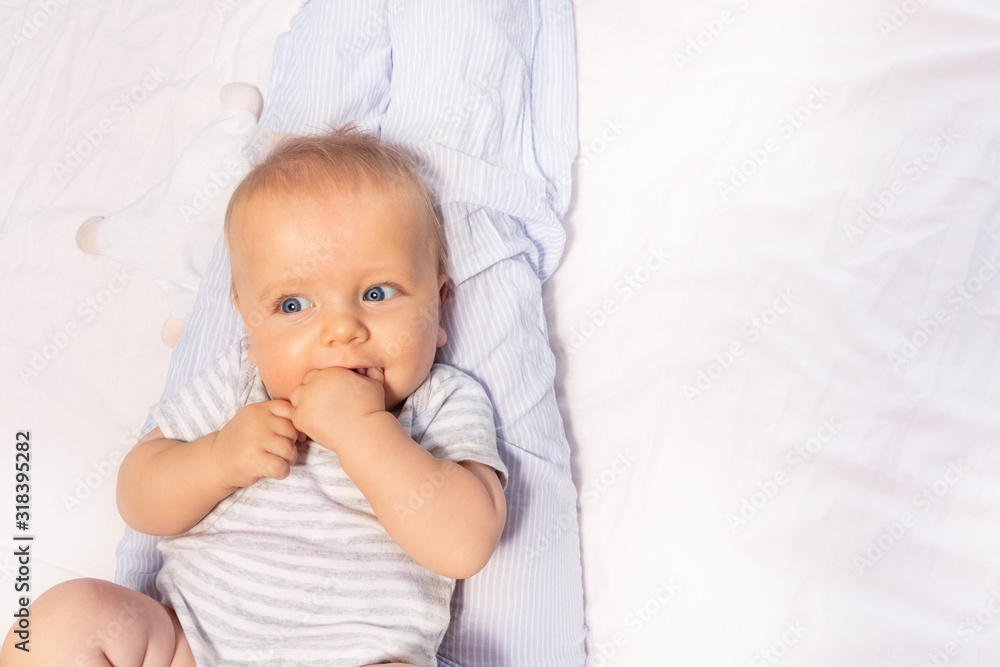 Calm happy face portrait of 6 month old baby with open mouth close-up Calm happy face portrait of 6 month old baby with open mouth close-up