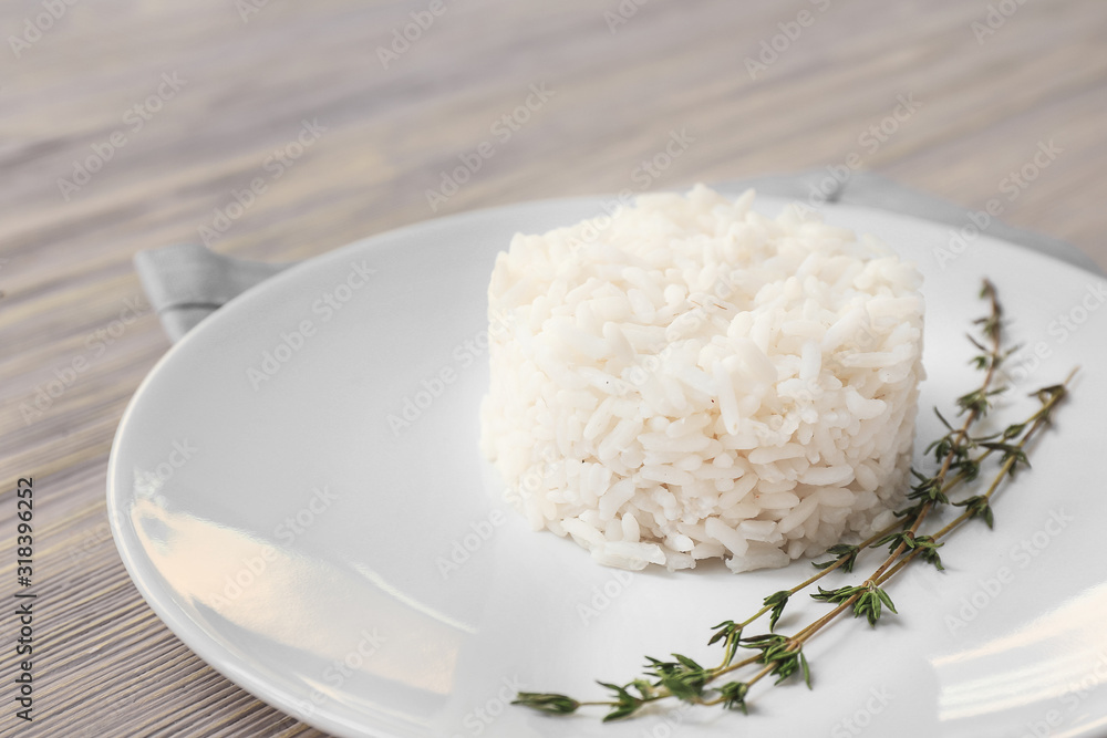 Plate with boiled rice on white wooden background Plate with boiled rice on white wooden background