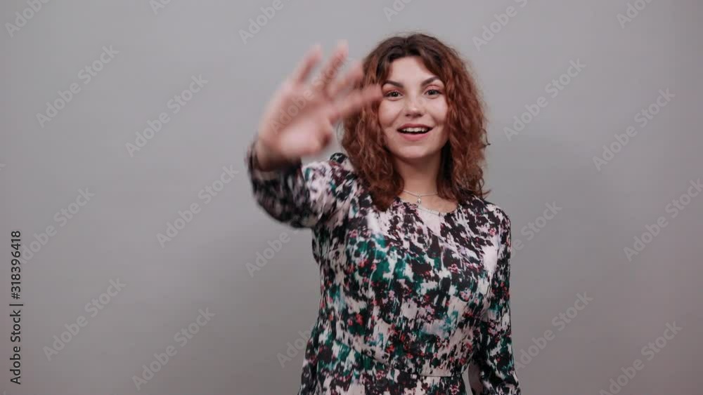 Serious charming young lady over isolated gray background in fashion shirt showing palms at camera, looking strict. People emotions. Lifestyle concept Serious charming young lady over isolated gray background in fashion shirt showing palms at camera, looking strict. People emotions. Lifestyle concept