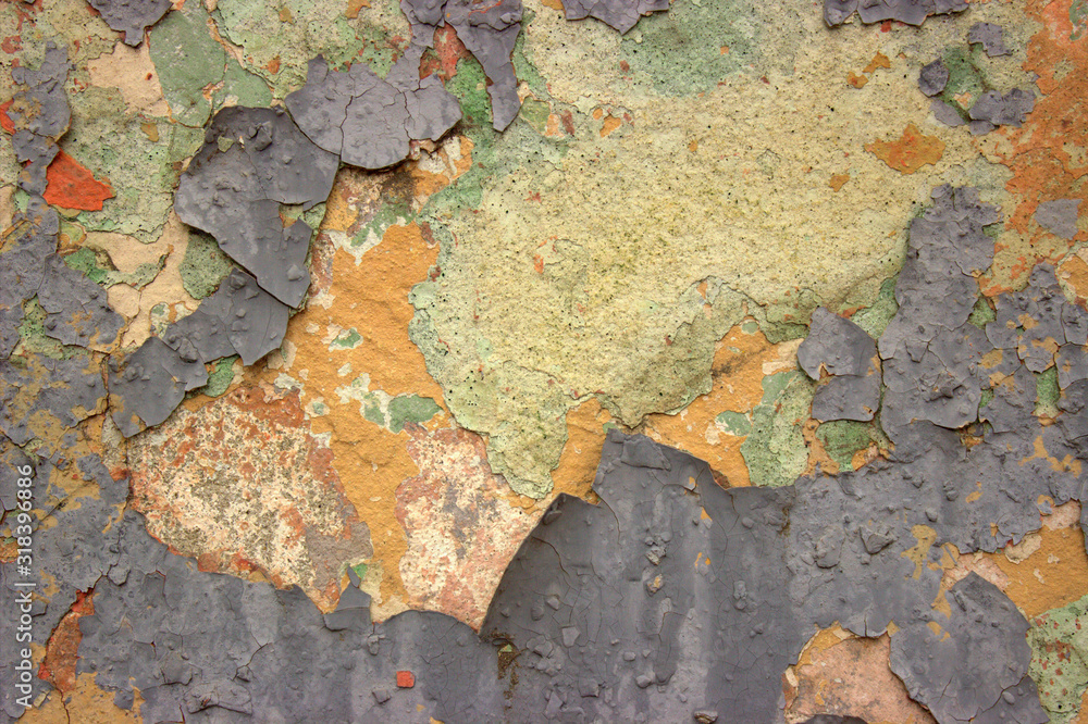 Wall of an old building with ragged green and orange paint Wall of an old building with ragged green and orange paint