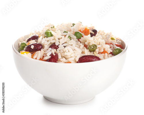 Boiled rice with vegetables in bowl on white background