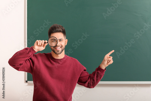 Male teacher with magnifier...