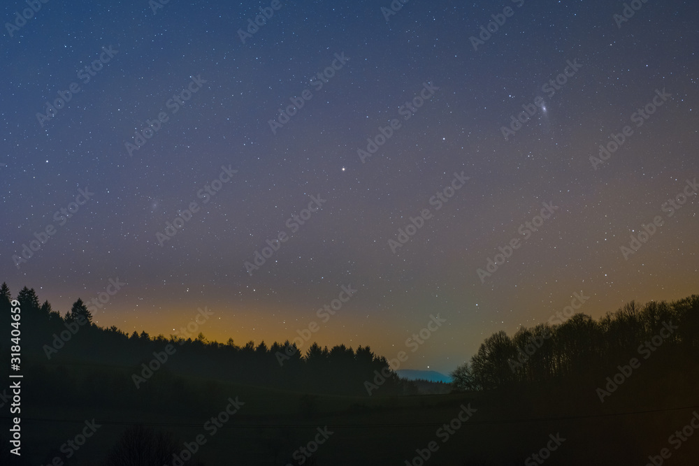 Night sky including the Triangulum and Andromeda Galaxy photographed from Lampenhain in the Odenwald in Germany.