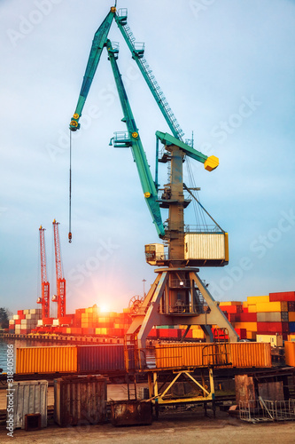 Industrial cranes loading freight containers for cargo ships. Logistic and transportation concept.