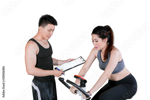 Beautiful woman doing workout with spinning bicycle