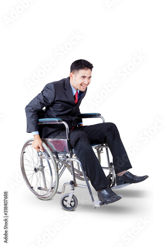 Happy businessman pushing his wheelchair