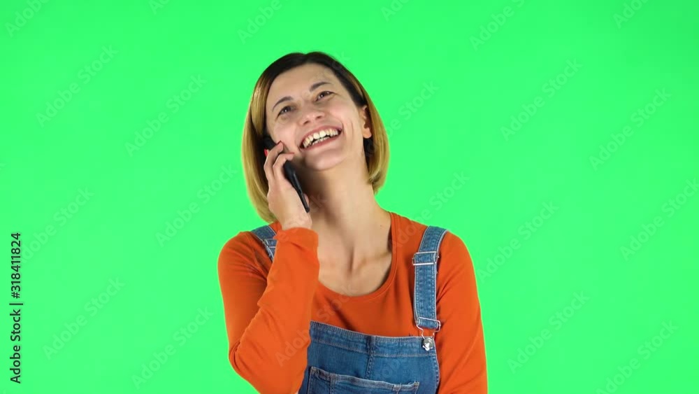 Smiling girl talking for mobile phone. Green screen Smiling girl talking for mobile phone. Green screen