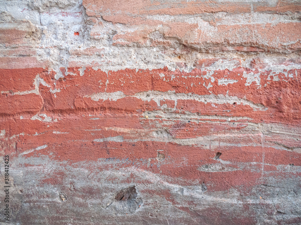 Background of a concrete wall with old traces of a red paint