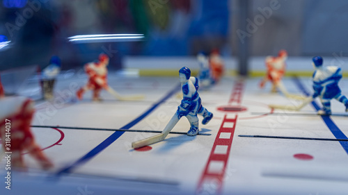 Up close shot of a worn figure of a hockey player in a blue uniform photo
