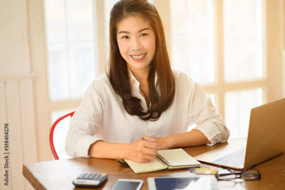 Head and shoulders portrait of smiling Asian businesswoman, success happy pose. E-commerce, internet technology, or startup small business concept. Modern office or living room with copy space Head and shoulders portrait of smiling Asian businesswoman, success happy pose. E-commerce, internet technology, or startup small business concept. Modern office or living room with copy space