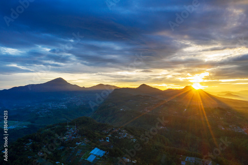 Drone view of foggy Puncak with sunrise beam