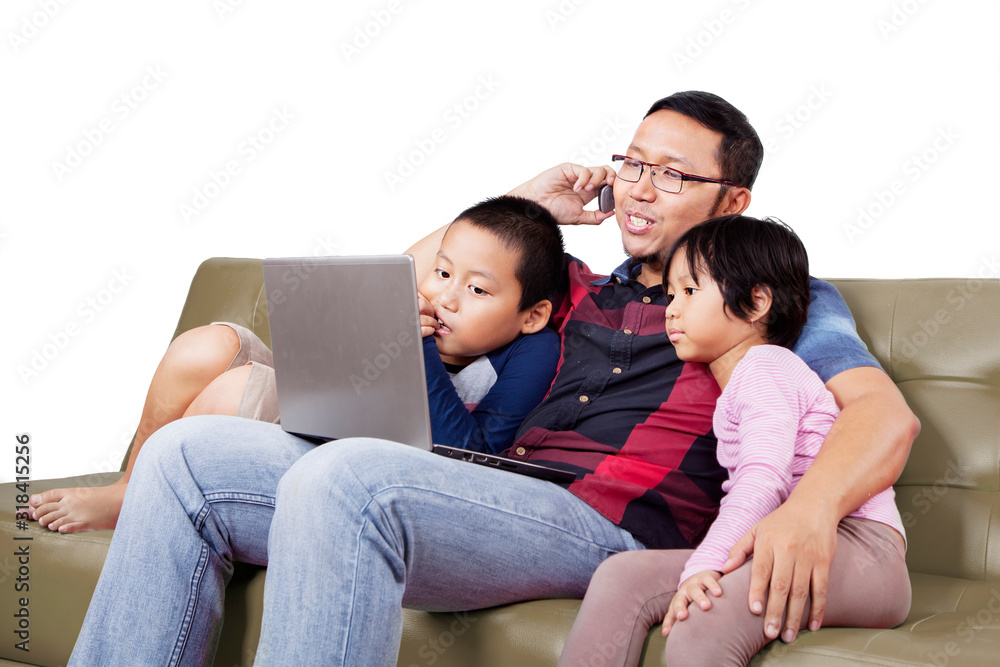Man teaching his children how to use a computer Man teaching his children how to use a computer