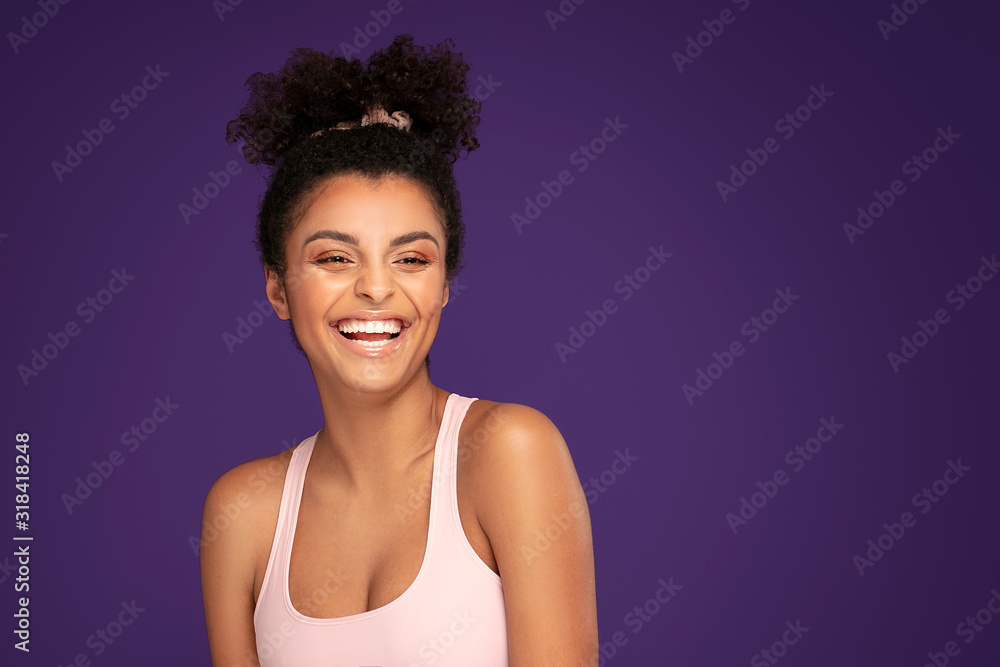 Fit afro girl posing in studio. Fit afro girl posing in studio.
