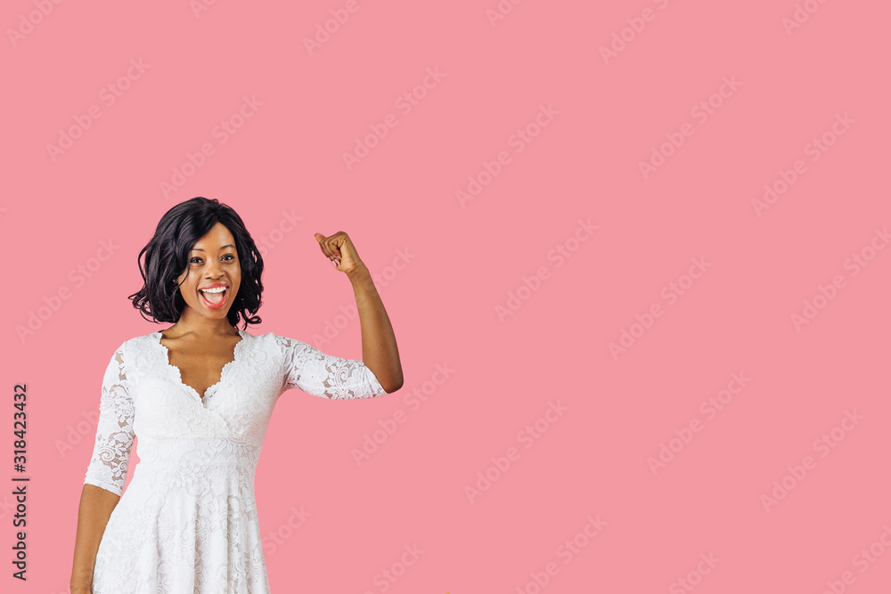 Portrait of young woman showing strength with her fist up Portrait of young woman showing strength with her fist up