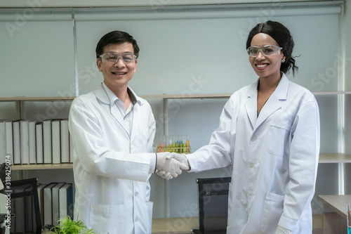 Scientists shake hands to do scientific experiments