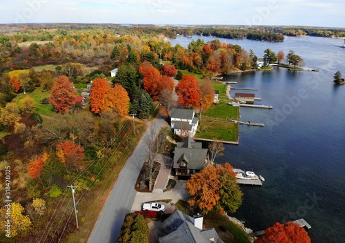 The aerial view of the residential area and waterfront homes surrounded by colorful fall foliage near Wellesley Island, New York, U.S.A photo