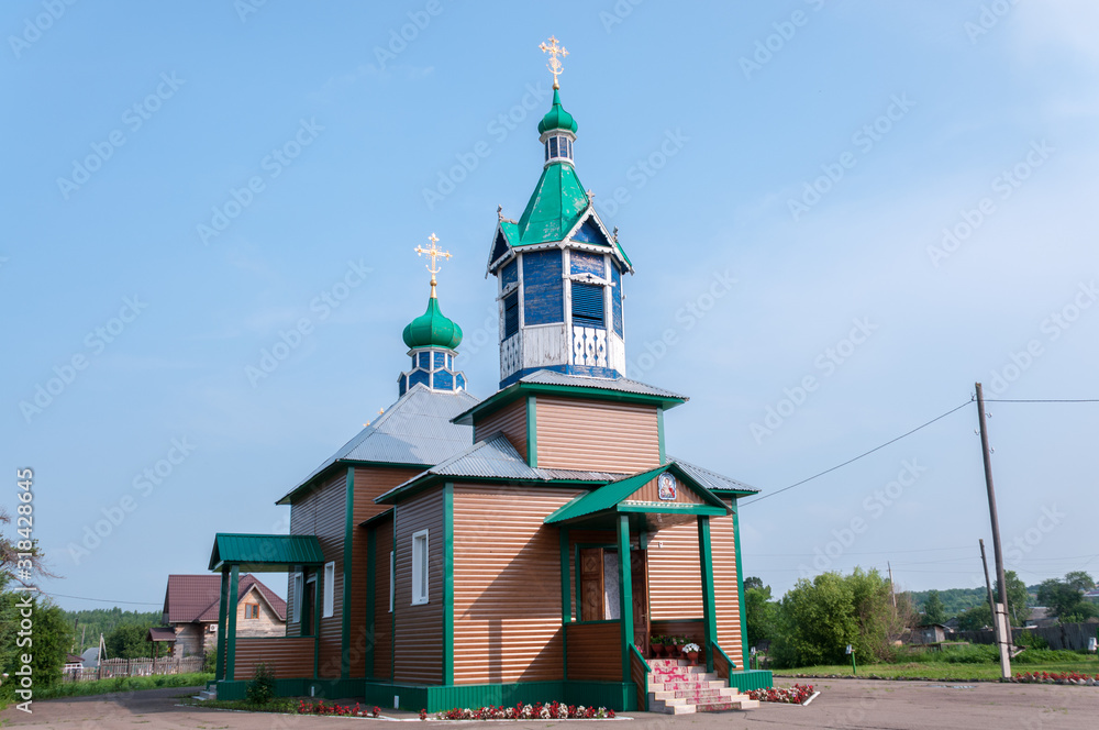 Russia, Blagoveshchensk, July 2019: Summer. Wooden rural Church in the village of Ignatievo near the city of Blagoveshchensk