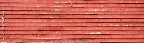 red peeling paint on weather worn red barn