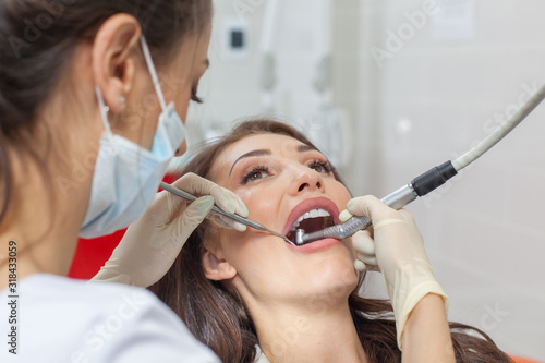 At the dentist. Female dentist in action