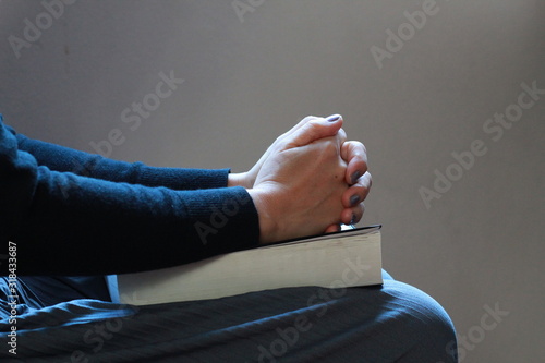 woman hands praying on the Holy Bible