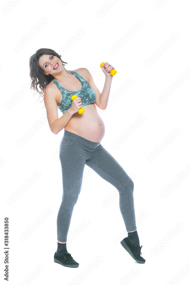 Pregnant woman training with dumbbells to stay active. Pregnant woman practicing fitness and working out during pregnancy Slim pregnant woman is engaged in fitness. Isolated white background. Pregnant woman training with dumbbells to stay active. Pregnant woman practicing fitness and working out during pregnancy Slim pregnant woman is engaged in fitness. Isolated white background.