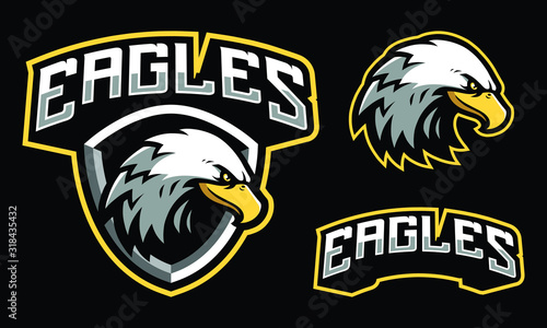 Eagles mascot logo design with extra shield for sport / e-sport logo isolated on black background