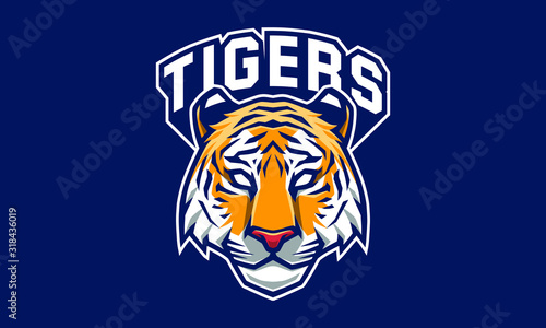 Tiger head mascot logo design with extra shield for sport / e-sport logo isolated on dark background