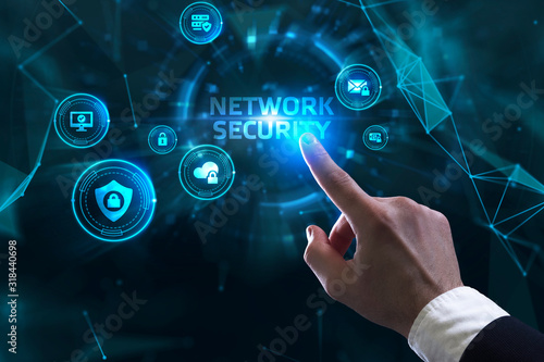 Business, technology, internet and networking concept. Young businessman working in the office, select the icon Network security on the virtual display.
